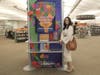 Author Mikki Brammer checks out library's One Book, One Village display.
