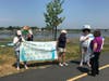 Protest signs. Wake Up The Earth event at Collins Cove