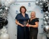 GMM Habitat CEO Liz DeCoursey (right) congratulates Mary Lou Panzano of Panzano Enterprises at the Hearts and Hammers Gala. Panzano was honored with the Donald H. Kuhn Inspiration Award. 