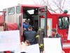 Patrick getting out of the fire truck to a crowd of students and teachers chanting his name with signs illustrating his strength.