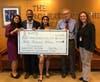 From left: Members of Om Parikh's family, Krupa Parikh, Ketal Parikh, and Yashaswi Parikh, present the first installment of a $150 thousand pledge to Dr. Maxim Yankelevich and Stephanie Kenyon of the Rutgers Cancer Institute Development Office.i