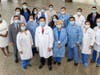 Dr. Isaac Kim (bottom, second from left) with members of his surgical team at Robert Wood Johnson University Hospital New Brunswick and Rutgers Cancer Institute of New Jersey along with hospital leadership. 