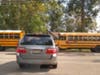 An SUV blocks the intersection as students walking and bicycling are forced to walk outside the crosswalk, against traffic, on Vail Road, a block from the middle school.