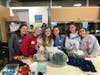 Kayla Herrick, Elizabeth Lynch, Bridget Mchallam, Catherine Lynch, Sabrina Paquin and Keira Denney pose with sorted and packaged items that will be distributed to local children in need. 