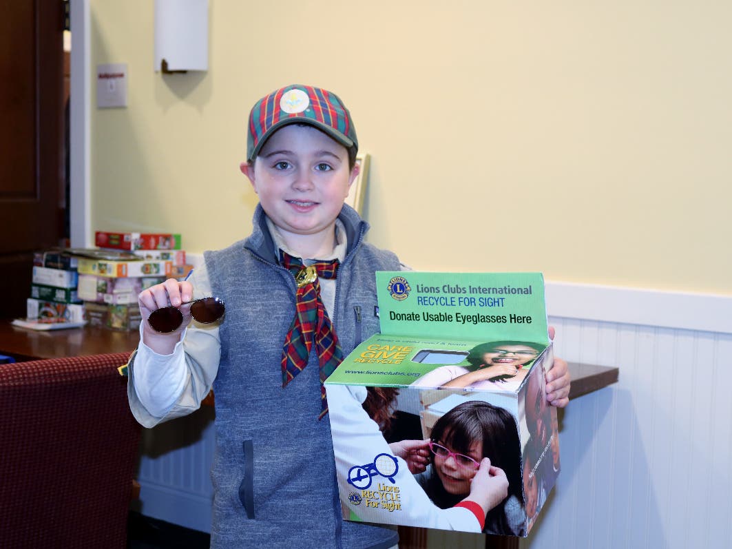 Pack 113's Ben Simonini collecting glasses at The Center in November 2019.