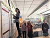 Middle school student volunteers clean off a whiteboard in a classroom at Blake Middle School.