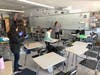 Middle school students help clean Blake Middle School classrooms by organizing books and recess equipment and wiping down the white boards, desks and chairs