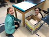 Middle school students help to clean classroom desks during Blake's Day of Service.