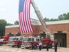 Flag tower, police and firefighters honoring Capt. Harman at Public Safety Bldg