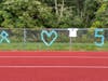 Fence around turf field decorated for Maddy Howard