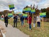 YES Signholders outside the polls on 11/15