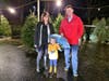 Happy family on the search for the perfect Christmas Tree at the Lions lot.