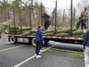 Lacrosse Team unloading trees