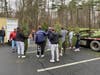 Lacrosse Team unloading trees