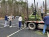 Lacrosse Team unloading trees