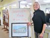 Roberta with a gift from her family - a framed image of The Center