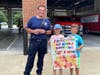 Campers presenting the THANK YOU poster to Medfield Fire Department