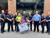 Campers presenting the THANK YOU poster to Medfield Police Department