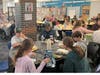 Visiting veterans joined sixth-grade class representatives and teachers for lunch in the school's library.