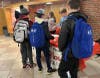 Seventh-grader Brooke Bender (back left) and sixth-grader Alexander Frank (back right) passed out flyers to students as part of the donor recruitment process in the months before the blood drive.