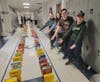 The cereal boxes were lined up like dominoes and knocked down while the sixth-grade students were able to watch.