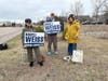 Roseli Weiss and helpers holding signs at the polls
