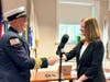 Town Clerk Marion Bonaldi congratulating Chief Bill DeKing