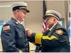 Medfield's Chief Bill DeKing III getting pinned by his dad, Chief Bill DeKing, Jr.