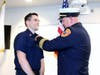 FF/Paramedic Collin Hern being pinned by Chief DeKing