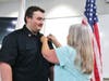 FF/Paramedic Bret Matthews being pinned by his mom.