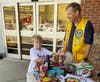 Lion Chris Carlin helping stack a large amount donated items.