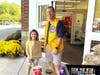 Lion Chris Carlin receiving a full bag of food items.