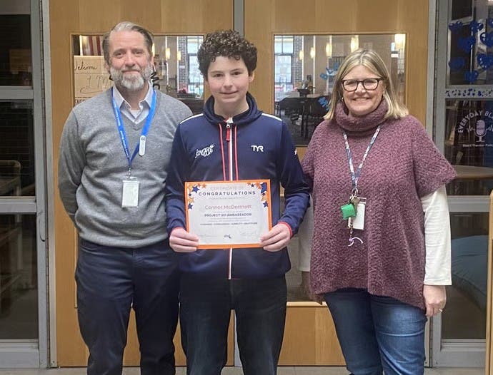 Blake Middle School Project 351 Ambassador Connor McDermott, center, with Principal Nat Vaughn, left, and Assistant Principal Kelly Campbell.