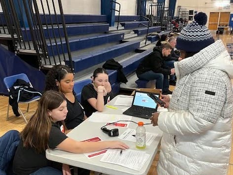 Blake students greet donors at the check-in table, where they fill out the paperwork necessary to donate blood.
