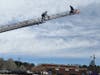 Captain Neil Kingsbury carrying buckets of balls to the end of the ladder truck.