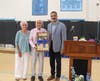 Principal Parga awarding the MHS Hall of Excellence plaque to Josh D'Amaro's parents