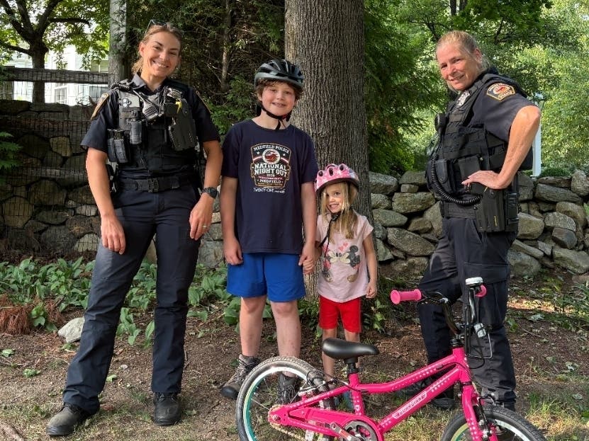 MPD Officer Mullaney (left) and MPD Officer Burton (right) with the young man wearing his new helmet.