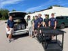 Lion Chris Carlin with members of Troop 89 unloading food drive collection