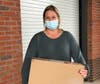 Megan from Hope Thru Soap picks up 500 masks to distribute at their winter coat pick-up event for homeless families.
