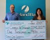 Lakeland Bank Branch Manager Eftychia Gizas (r) presents a $1,000 check to Charles Gearhart III. Gearhart was randomly selected as a winner of the Lakeland Bank 50th Anniversary Debit Mastercard® Sweepstakes.