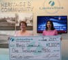 Lakeland Branch Manager Mira Cocozziello (r) presents a $1,000 check to Marie Drangula. Drangula was randomly selected as a winner of the Lakeland Bank 50th Anniversary Debit Mastercard® Sweepstakes.