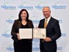 Lakeland Bank’s Jennifer Hopper stands with John McWeeney, President and CEO of NJ Bankers as she accepts the Emerging Leaders Program certificate.
