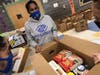 Ashley Mojica helps fill Thanksgiving Dinner boxes