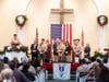 Avon Scoutmaster Rob Schwarzhopt addresses the crowd of Avon Scouts, Scout leaders, parents and siblings at the Jan. 4 ceremony held at West Avon Congregational Church. 