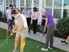 A student tries her hand at making a putt with Ruth Lang, resident at Grace Point Place.