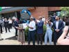 W. Todd Groce, PhD, unveils the Historical Marker for H. J. Russell & Company as Michael, Donatat and H. Jerome Russell look on from the rear and many of their children look on after all having participated in the reading of the marker.