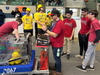 Team Apple Pi’s Drive Team prepares their robot to enter the competition field, along with mentor Andrew Donorumo. 