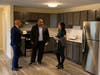 Lawrence Mayor Brian DePeña, MassDevelopment President & CEO Dan Rivera, and state Rep. Christina Minnicucci, in the kitchen of a new apartment at 370 Essex Street, Lawrence.