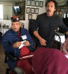 Aide Corrine Welch, Veteran Ellwyn Harvic enjoying his chicken lunch, and Lodge Esquire Gilbert Rodela