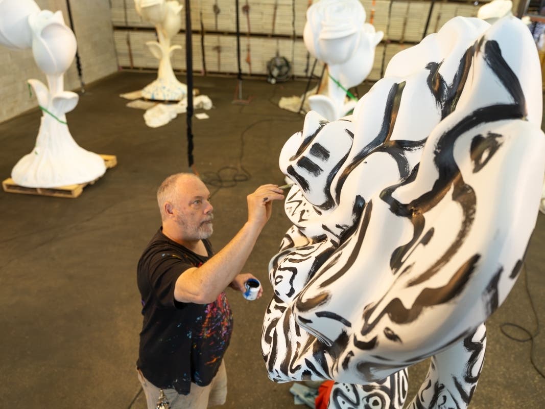 Chicago artist Nicholas Barron paints his Rosemont in Bloom sculpture, “ITSA Barron Rose.”